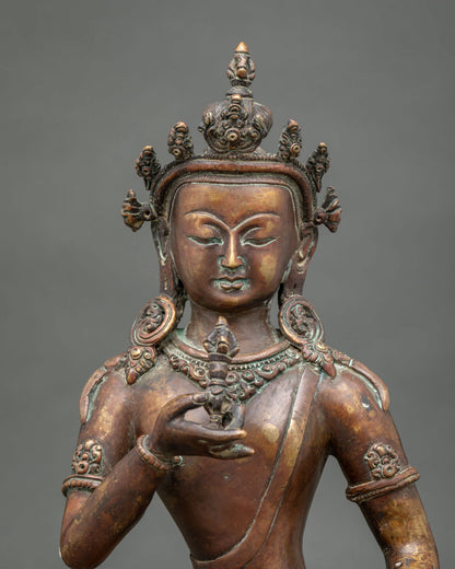 Vajrasattva statue close up serene face jeweled crown and antique finish.