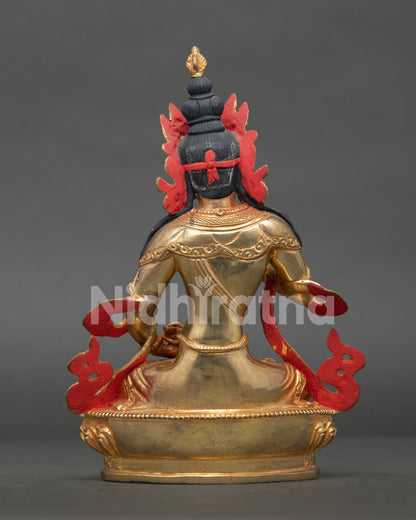Vajrasattva statue displaying intricate gold gilded artwork and nepalese craftsmanship.
