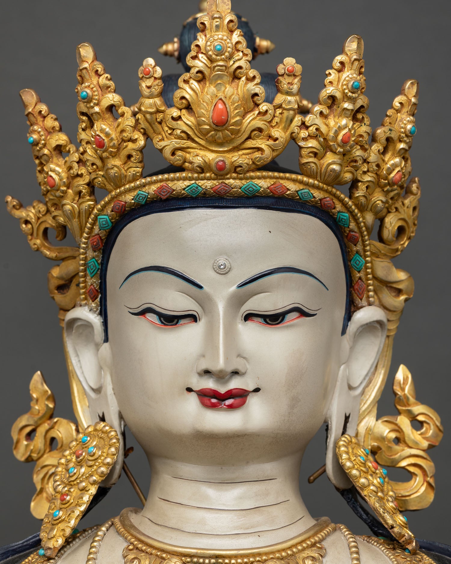 Vajrasattva statue face close up, hand-painted serene expression, third-eye urna, gold five-pointed diadem crown Nepal