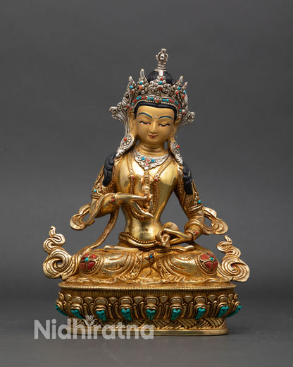 vajrasattva statue front view, gold fire-gilded nepalese buddhist sculpture on lotus base