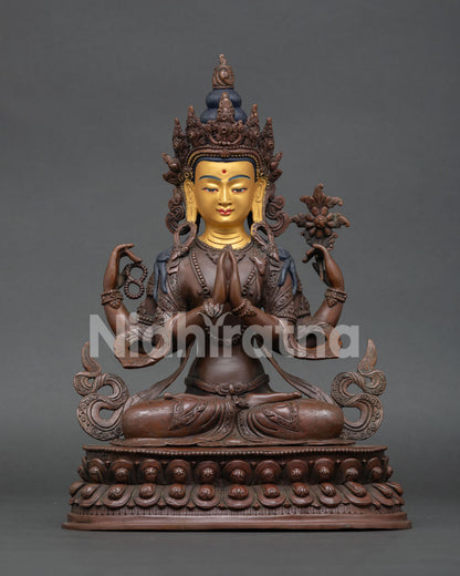 Vajrasattva statue handcrafted in Nepal with oxidized copper finish and gold painted face.