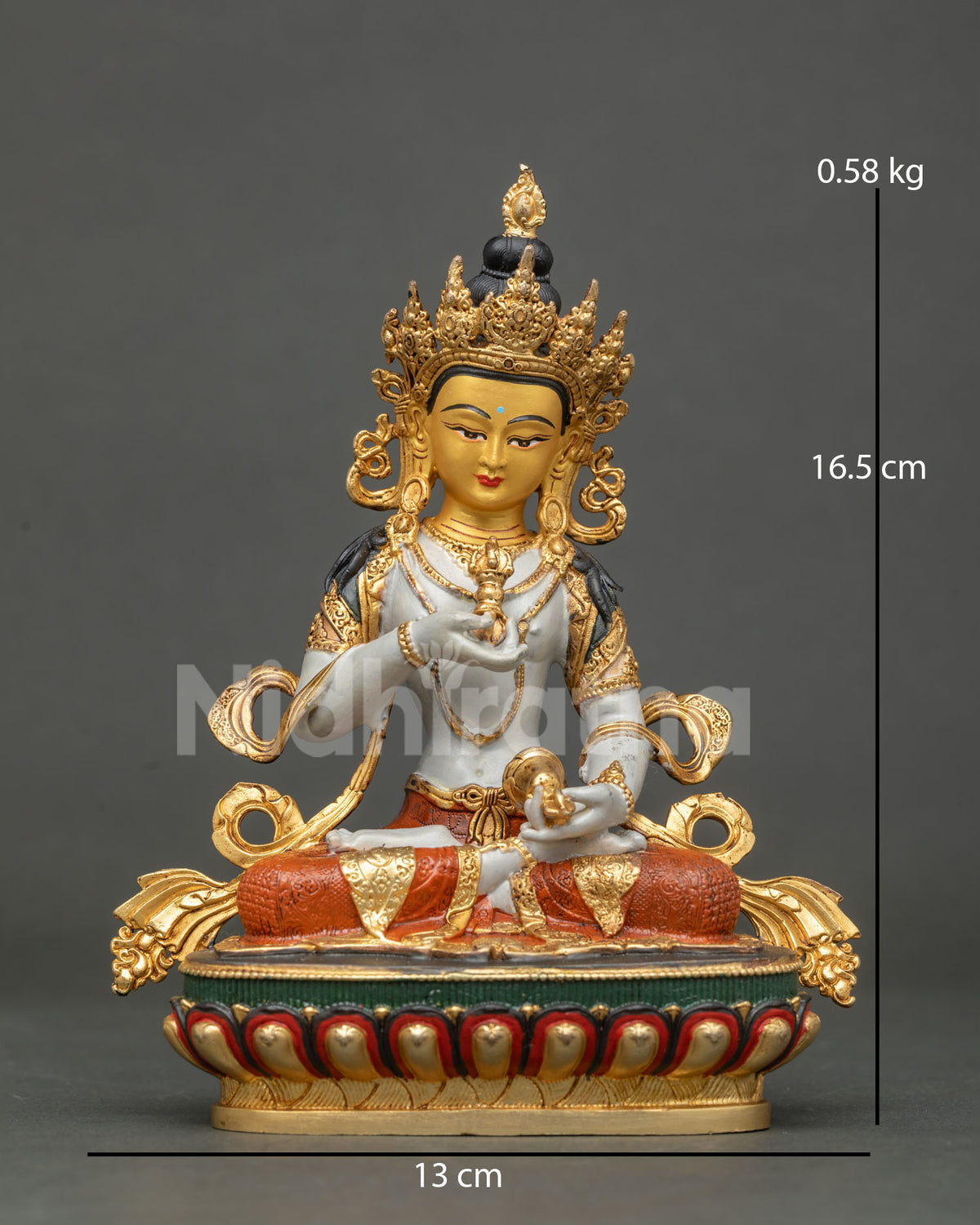 Vajrasattva statue holding five pronged vajra and bell.