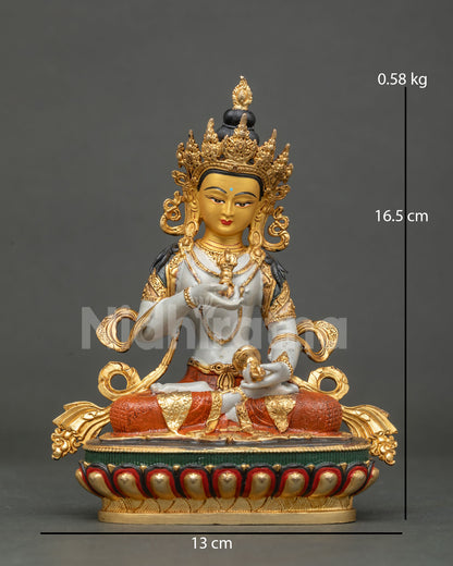 Vajrasattva statue holding five pronged vajra and bell.