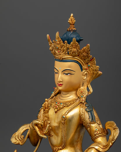 Vajrasattva statue holding vajra and bell adorned with turquoise and coral stones.