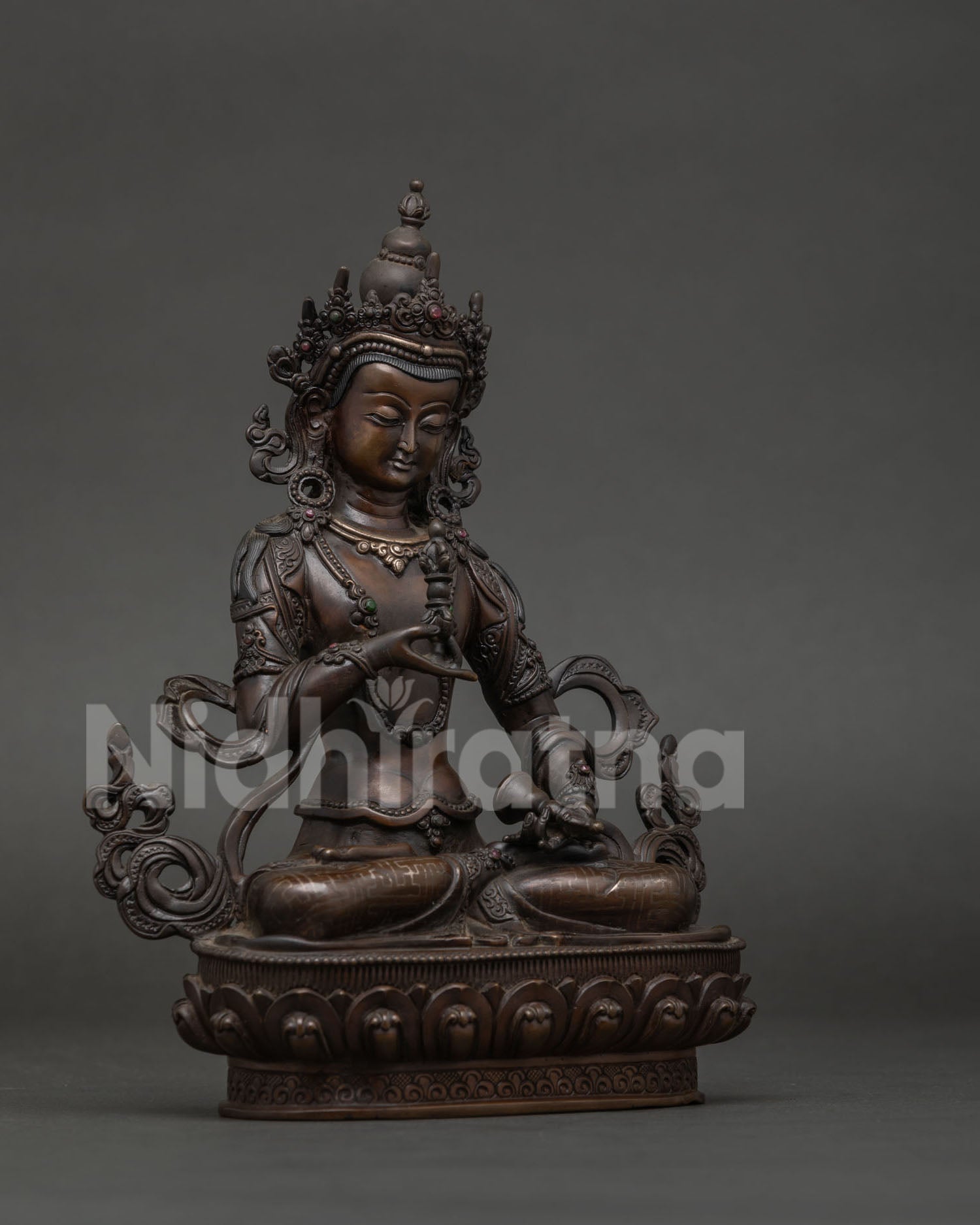 Vajrasattva statue holding vajra and bell symbolizing wisdom and compassionate practice.