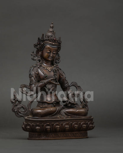 Vajrasattva statue holding vajra and bell symbolizing wisdom and compassionate practice.