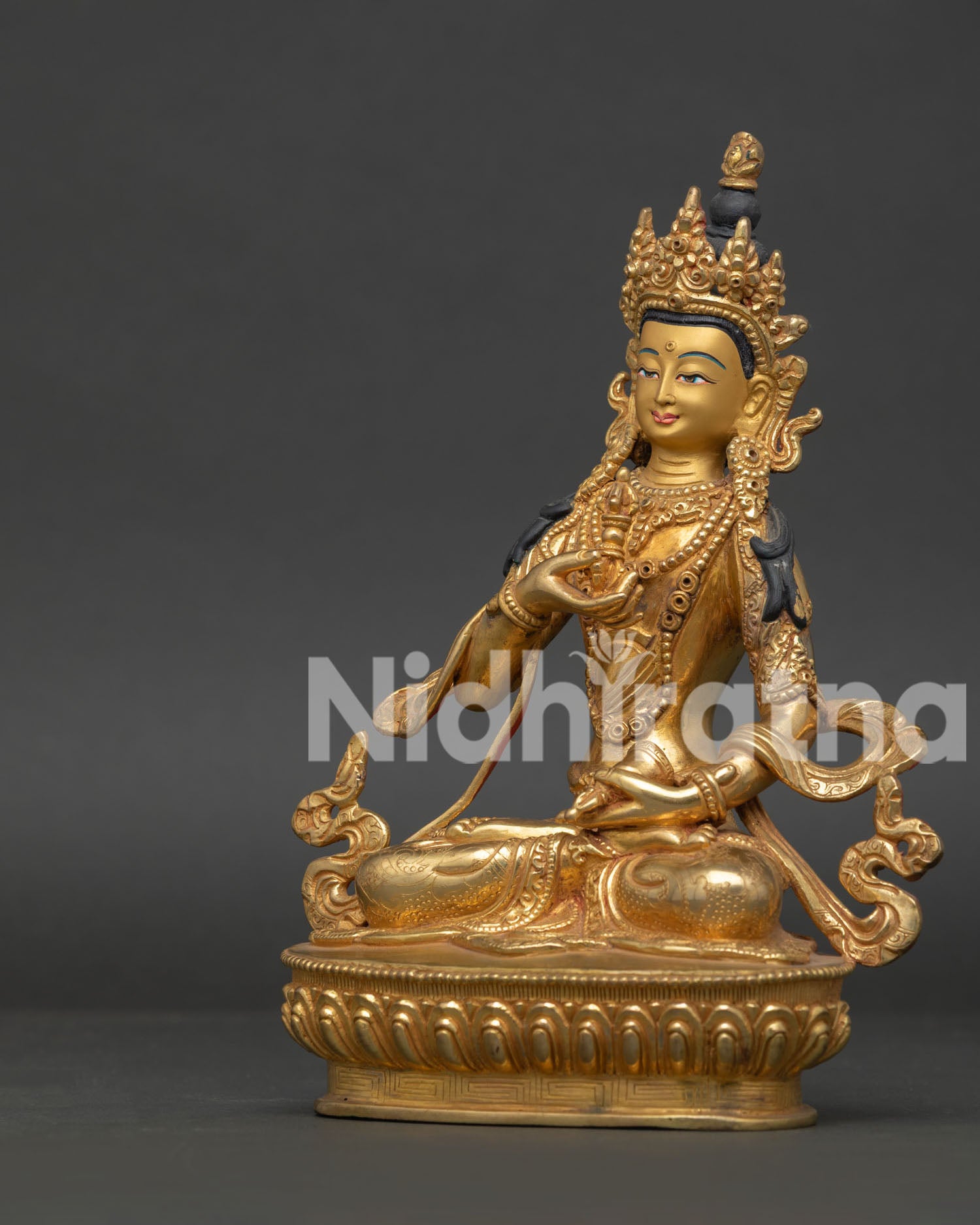 Vajrasattva Statue seated on lotus pedestal holding vajra and bell Buddhist art.