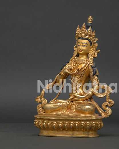 Vajrasattva Statue seated on lotus pedestal holding vajra and bell Buddhist art.