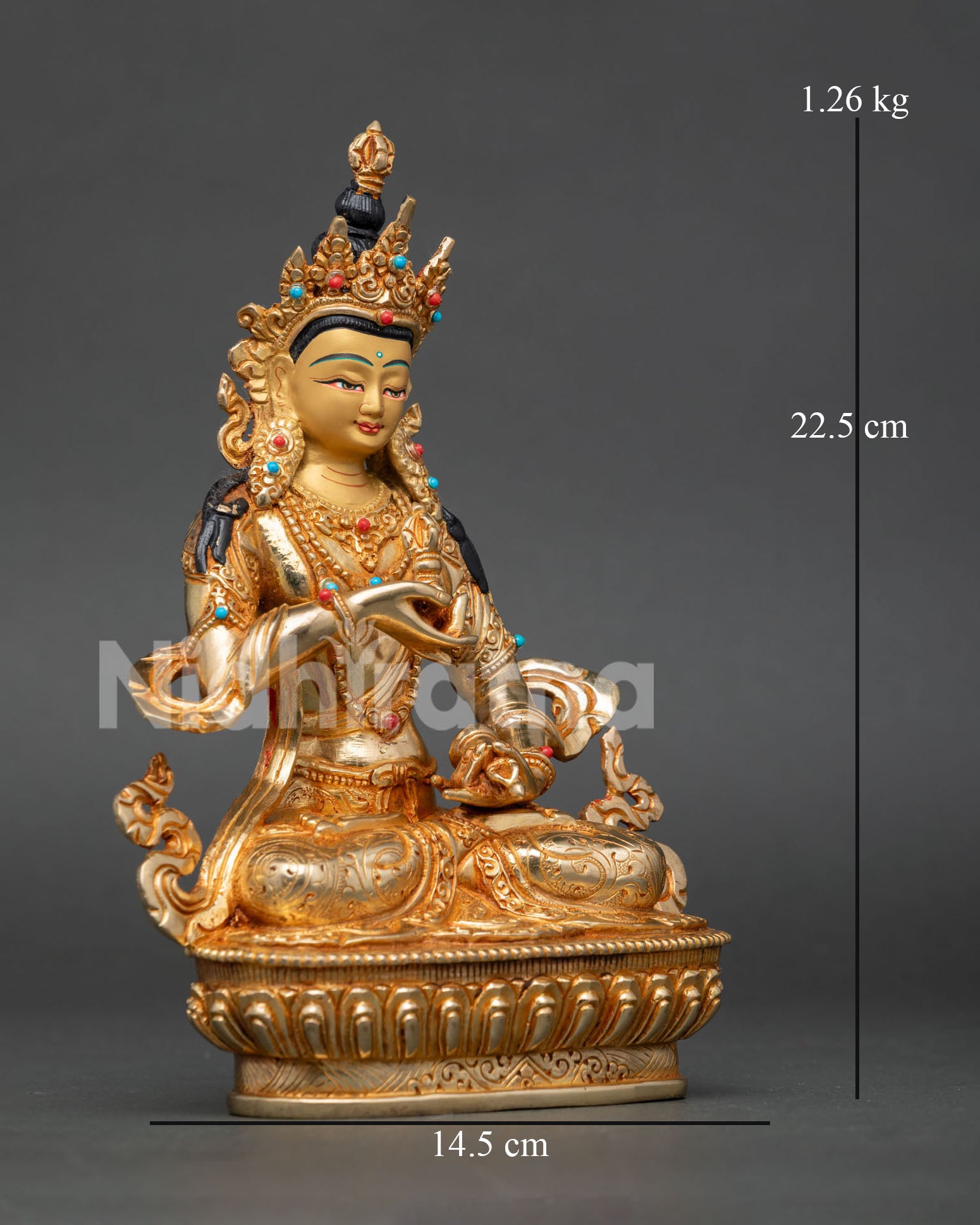 Vajrasattva statue seated on lotus pedestal, holding vajra and bell, symbolizing compassion and wisdom in Buddhist practice.