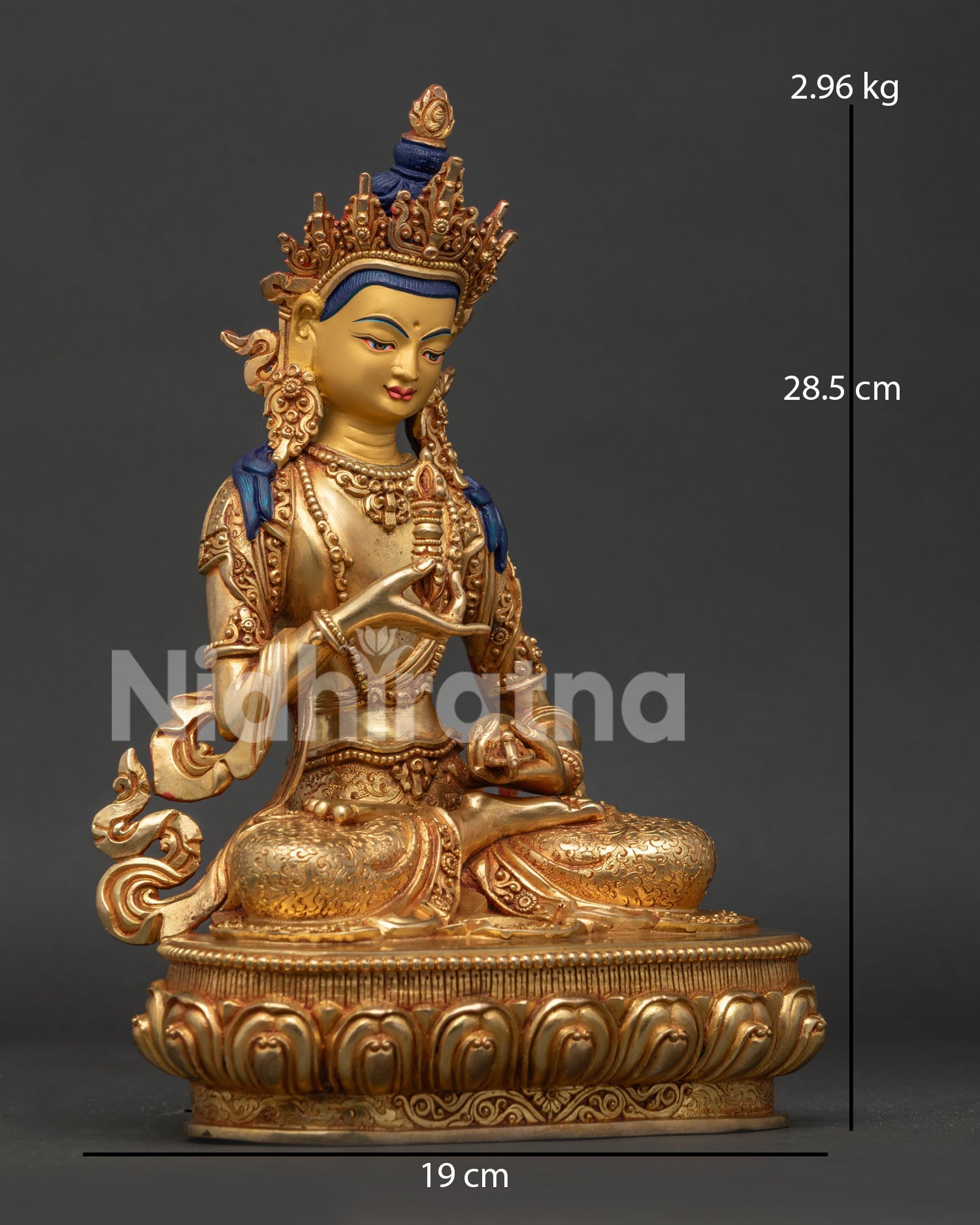Vajrasattva statue side view holding vajra and bell with flowing celestial scarf details.