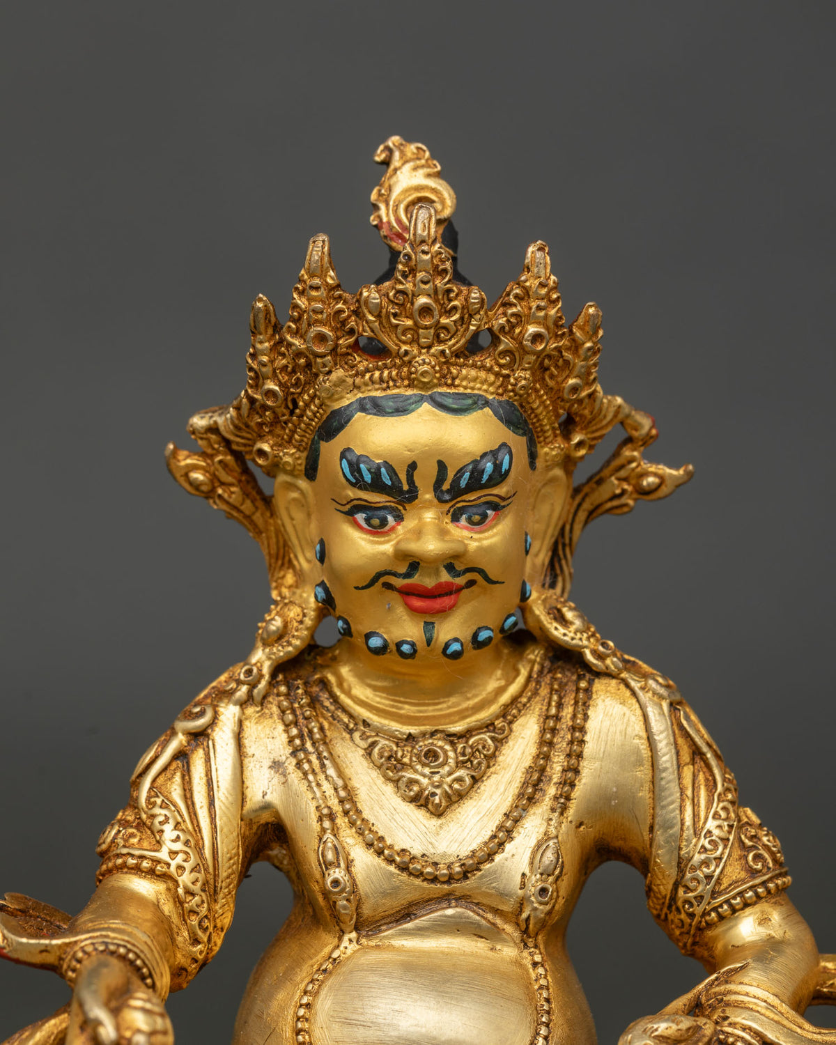 Vajrayana dzambhala sculpture in copper with 24k gold painted face on hand carved lotus pedestal.