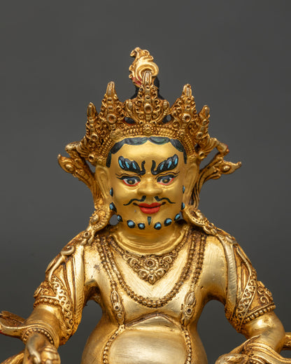 Vajrayana dzambhala sculpture in copper with 24k gold painted face on hand carved lotus pedestal.