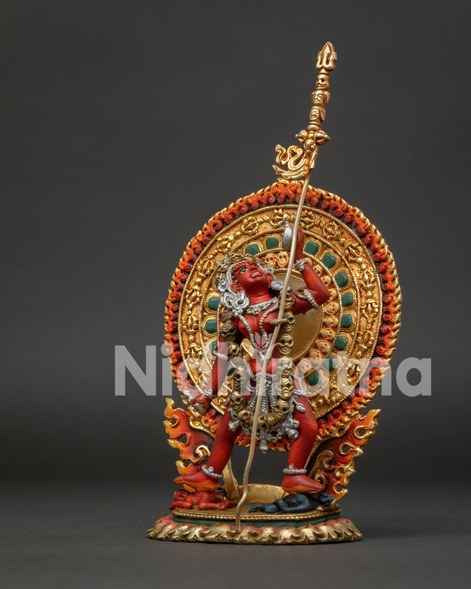 Vajrayogini dancing above a subdued figure with a skull cup and khatvanga staff.