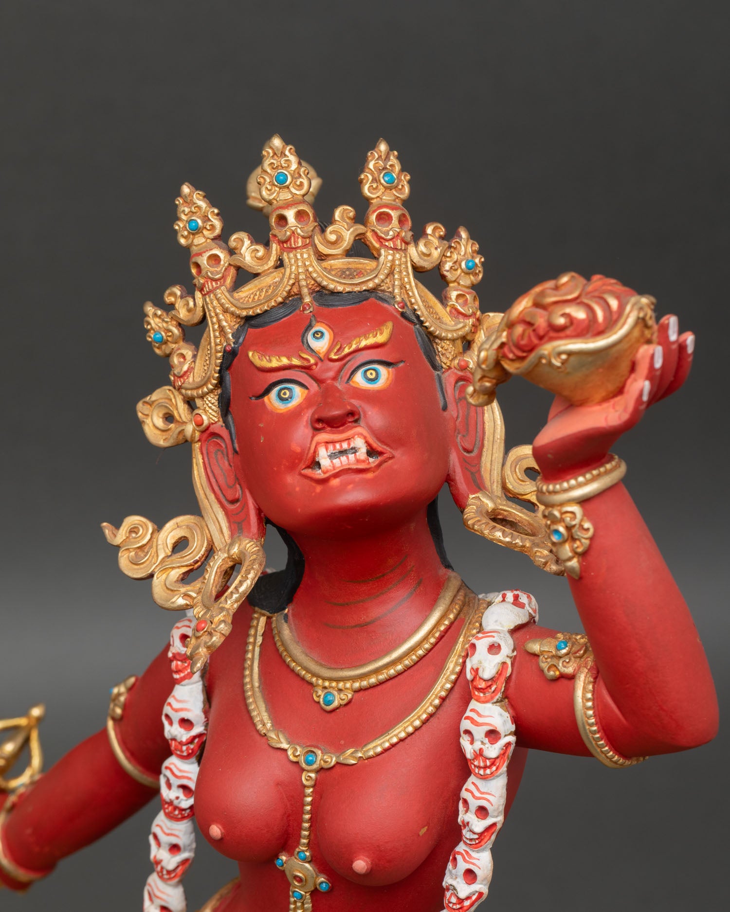 vajrayogini side face close up wrathful dakini expression gold crown ornament detail