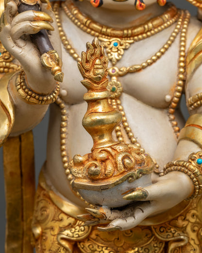 White Mahakala hand holding a skull cup with wish-fulfilling jewel, gold gilding and acrylic colors
