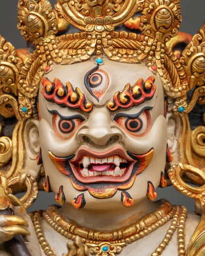 White Mahakala three-eyed face with bared fangs, wrathful gaze and turquoise and coral crown