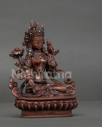 White tara buddhist statue seated on hand carved lotus pedestal with semi precious stones.