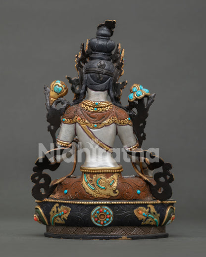 White Tara sculpture with lotus flowers beside shoulders representing wisdom and enlightenment