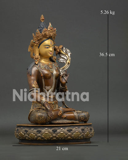 White tara seated on ornate lotus pedestal with five jewel crown and semi precious stones.