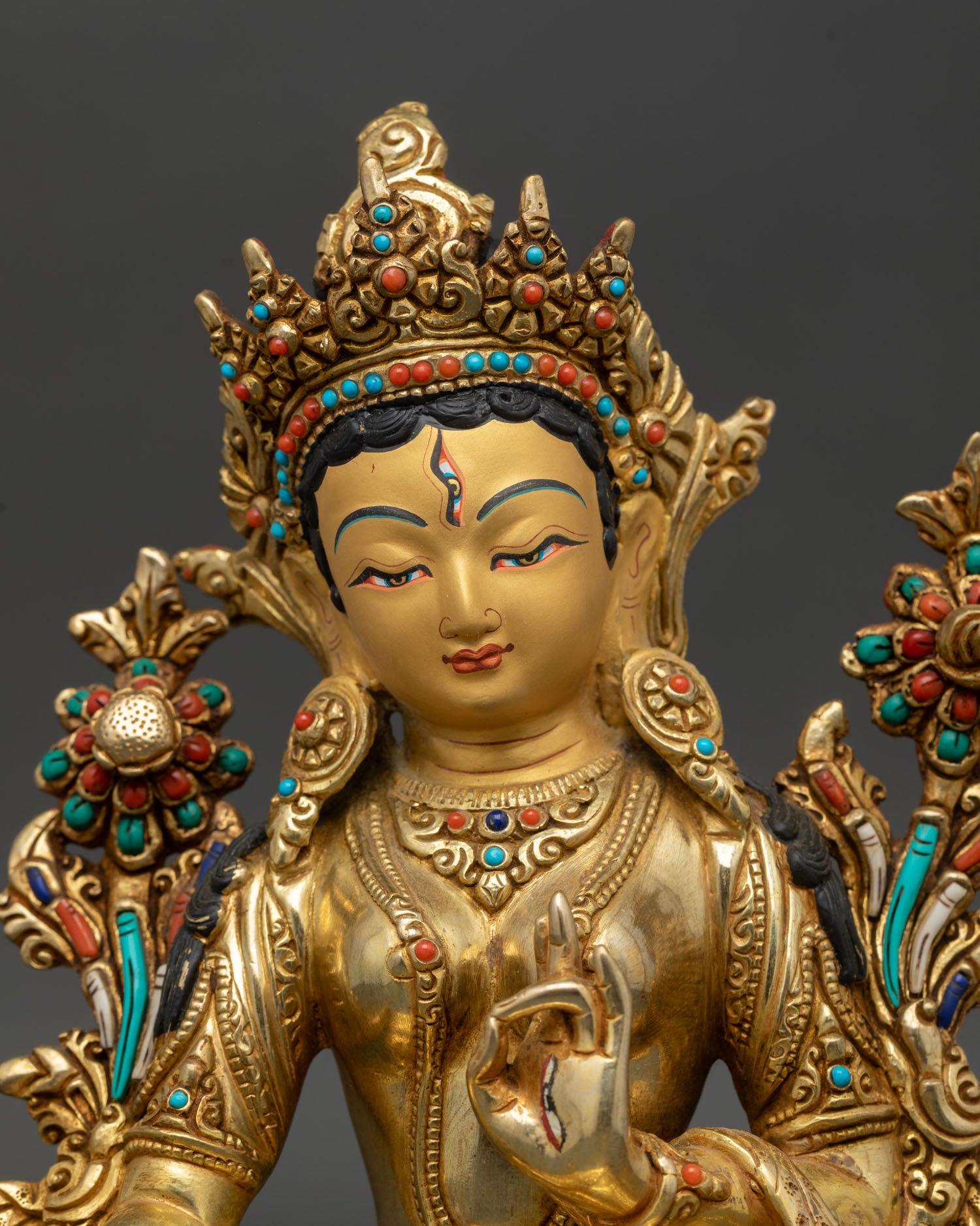 White Tara seven eyes detail close up gold gilded face Nepal Kathmandu Valley lost wax handcrafted healing goddess statue