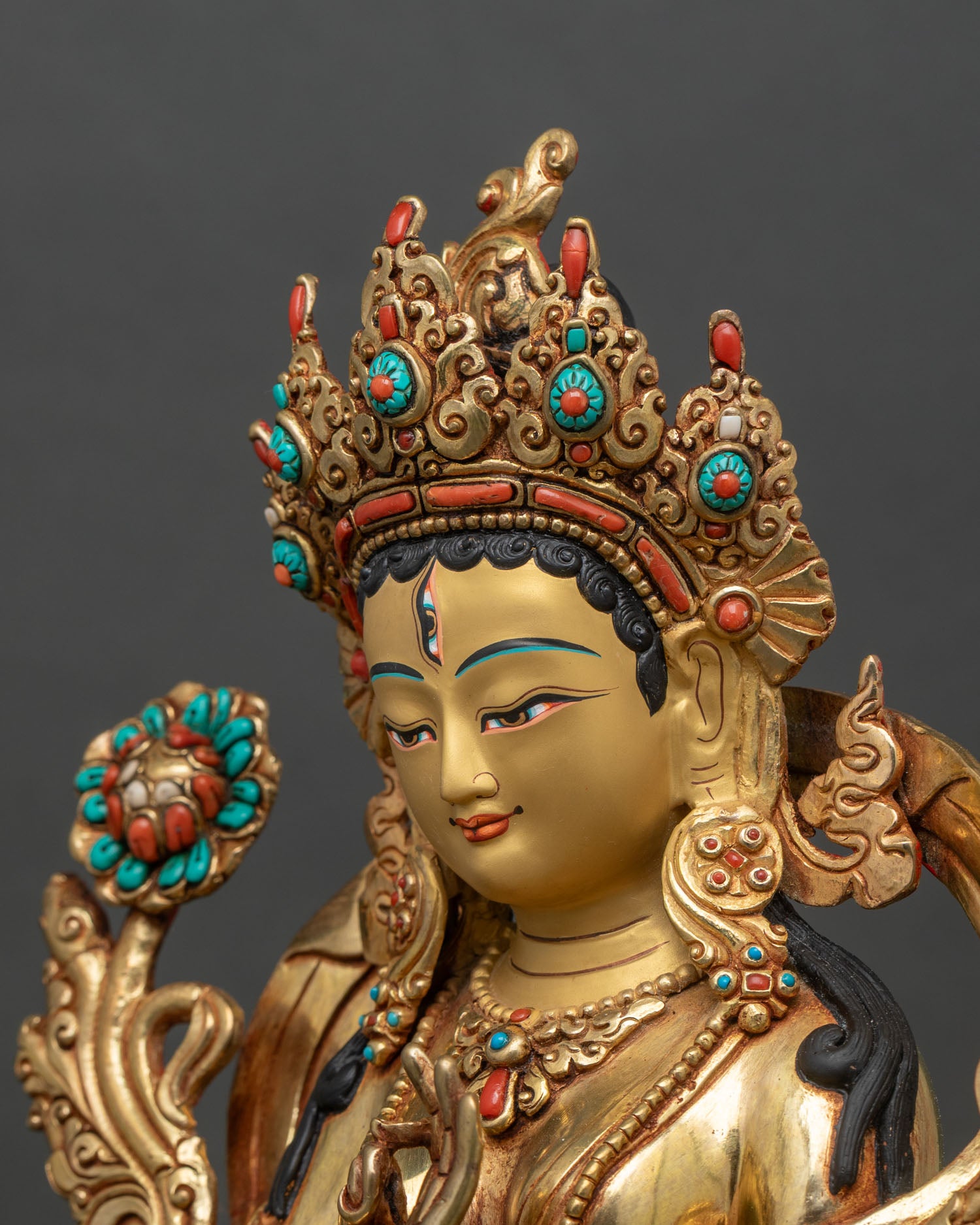 Detailed side close-up of White Tara holding utpala flower on lotus throne