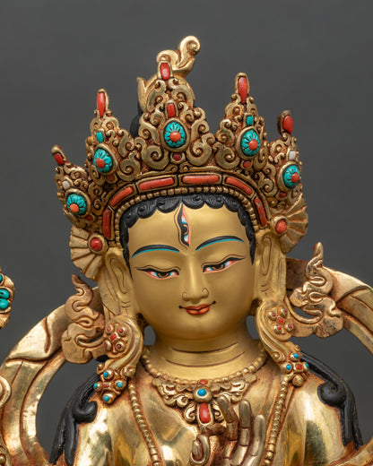 Close-up of White Tara statue showing gold gilding and floral garments