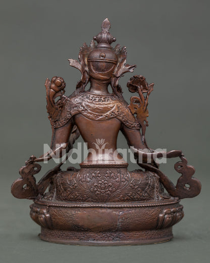 White tara statue displaying detailed copper artwork and himalayan buddhist design.