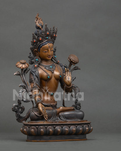White Tara Statue from Nepal seated on lotus pedestal with seven eyes.