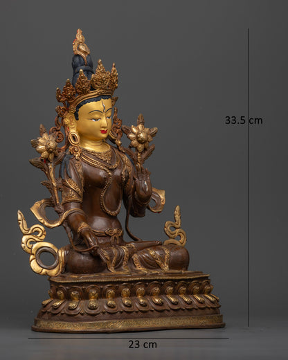 White Tara statue featuring a 24K gold painted face and delicate lotus flowers rising beside her shoulders.
