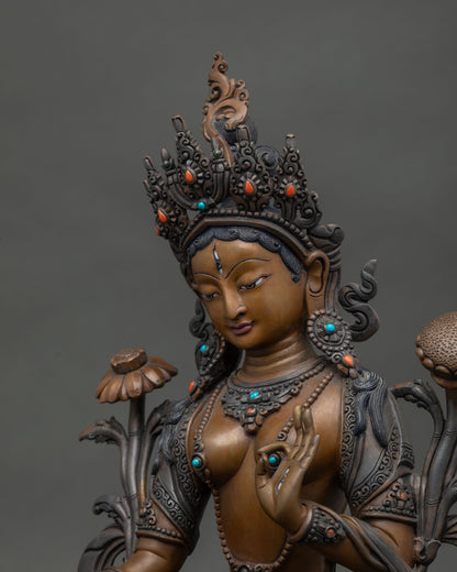 White Tara Statue holding utpala flower in blessing gesture.