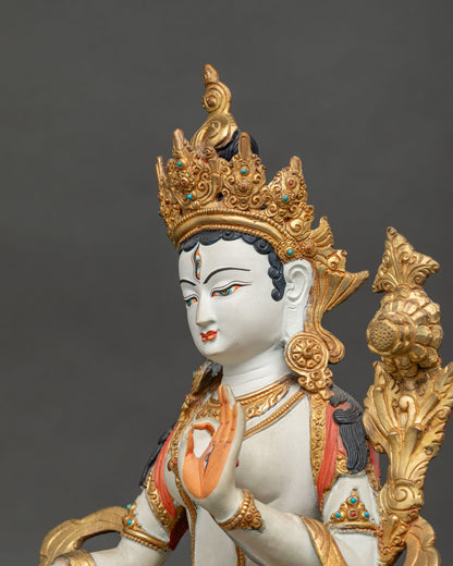White Tara statue adorned with intricate floral motifs semi precious stones and traditional Buddhist details.