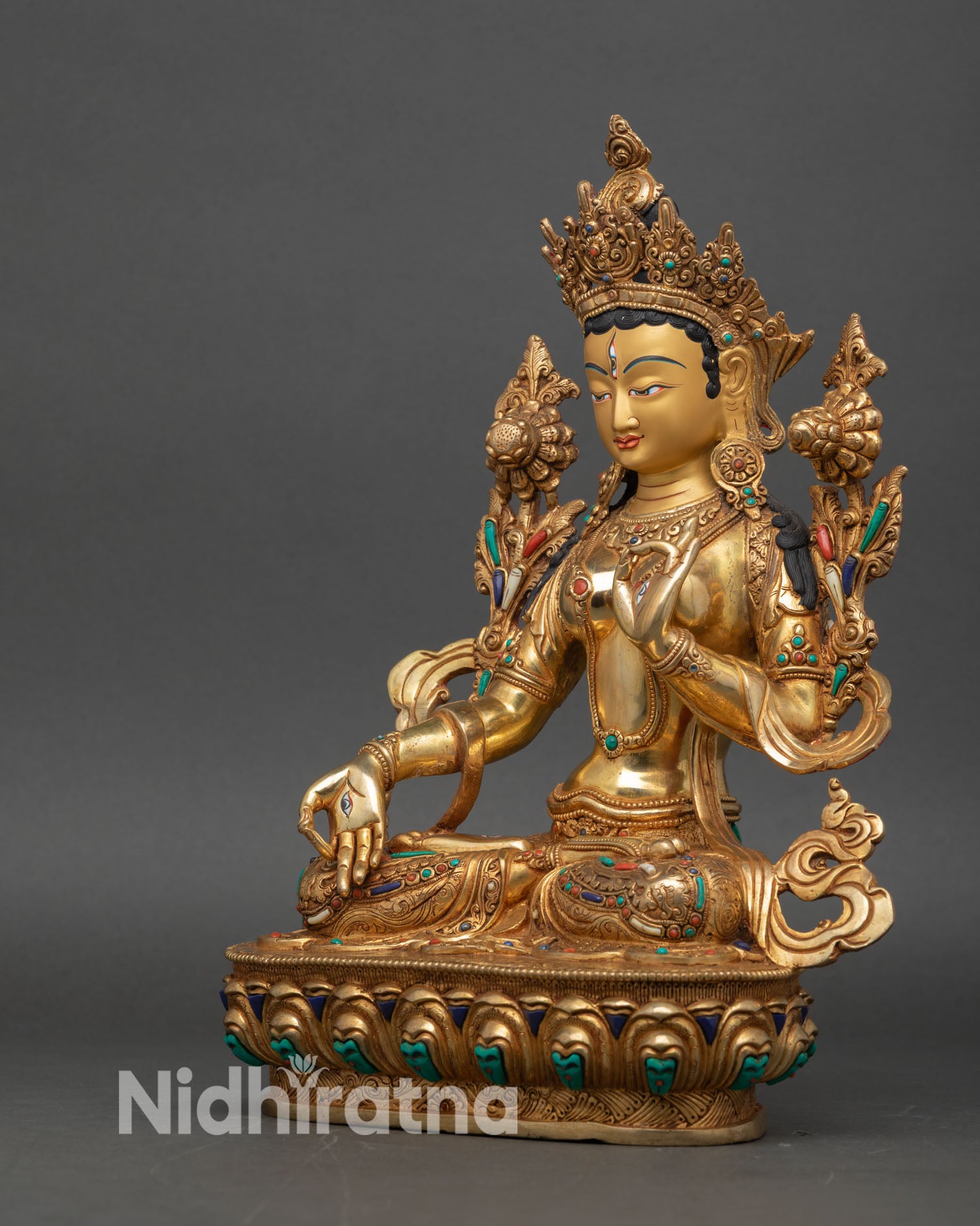white tara statue left side view, intricate lotus throne and dhoti folds with semi-precious stones