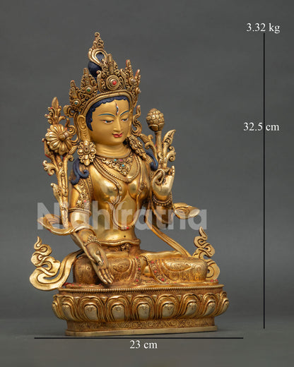 White Tara statue, seated on lotus pedestal holding lotus flower