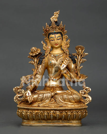 White tara statue seated on lotus pedestal holding three bloom lotus flower.