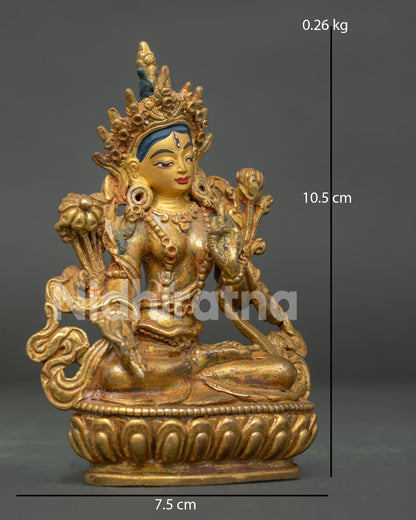 White Tara statue showing seven compassionate eyes and lotus pedestal.