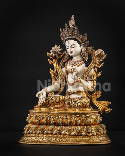 White Tara statue showing serene posture and lotus base symbolism