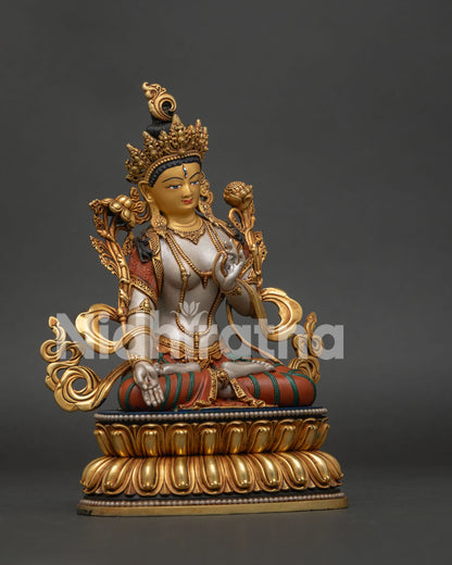 White Tara Statue shown from the left side with hand-carved details, lotus pedestal and 24K gold gilding