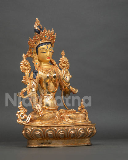 White Tara Statue side view semi precious gemstones ornate gold jewelry.