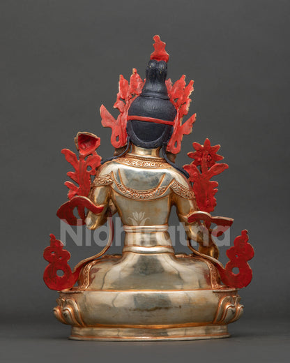 White Tara statue with gold gilded copper robes lotus pedestal and ornate hand chased floral decorations.