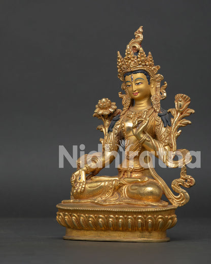 White Tara statue with seven eyes and gold gilded copper finish.