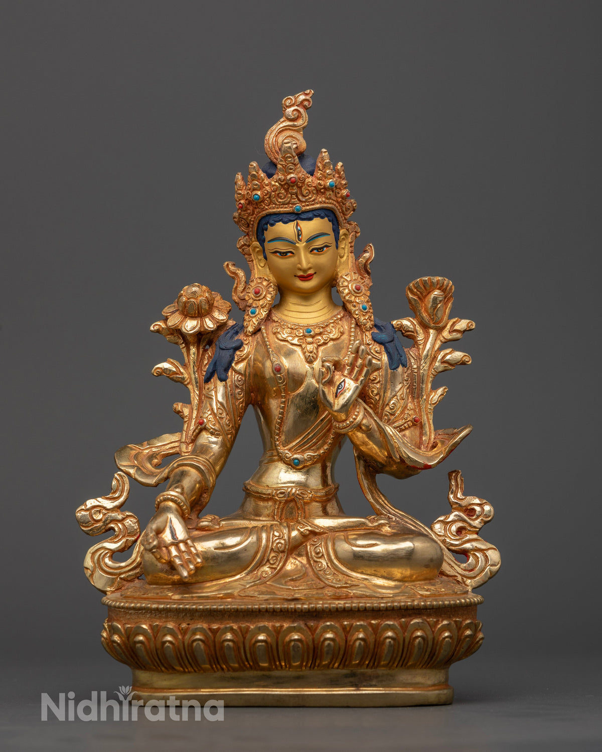 White Tara statue with seven eyes on forehead palms and soles.