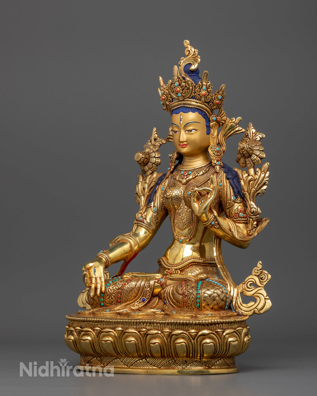 another side view of golden white tara statue adorned with gemstones