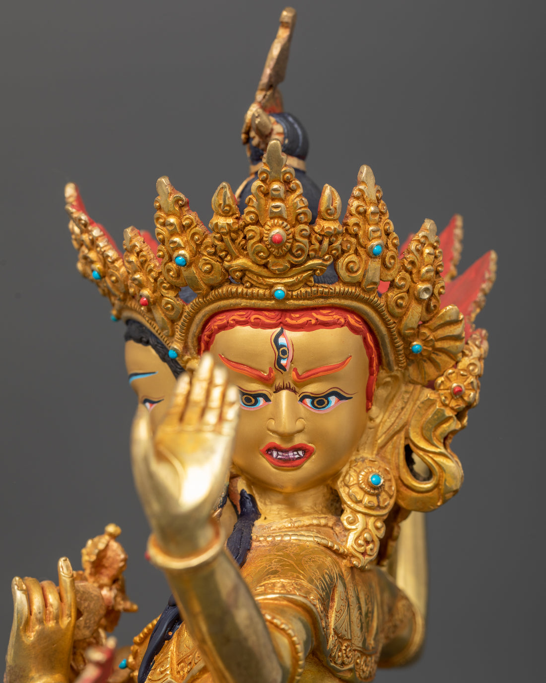 one wrathful face of namgyalma statue out of three faces