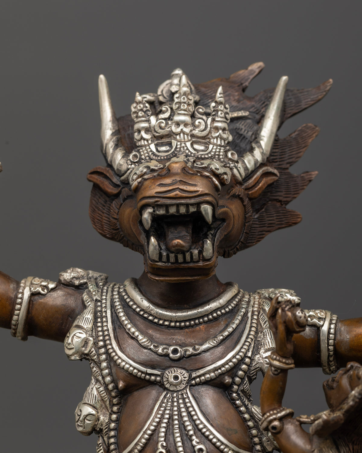 Yamantaka statue holding staff and lasso with intricate Vajrayana details.