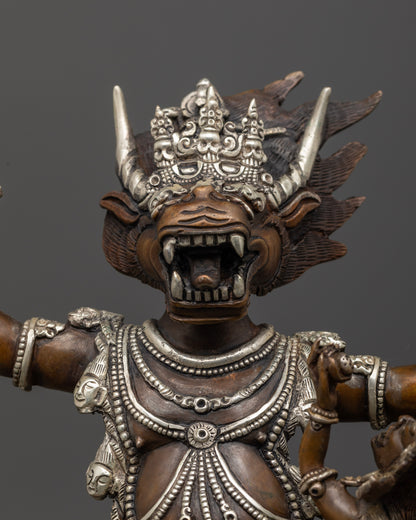 Yamantaka statue holding staff and lasso with intricate Vajrayana details.