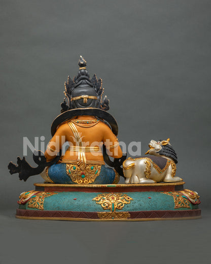 Yellow Dzambhala statue back view black crown teal lotus base copper Buddhist sculpture
