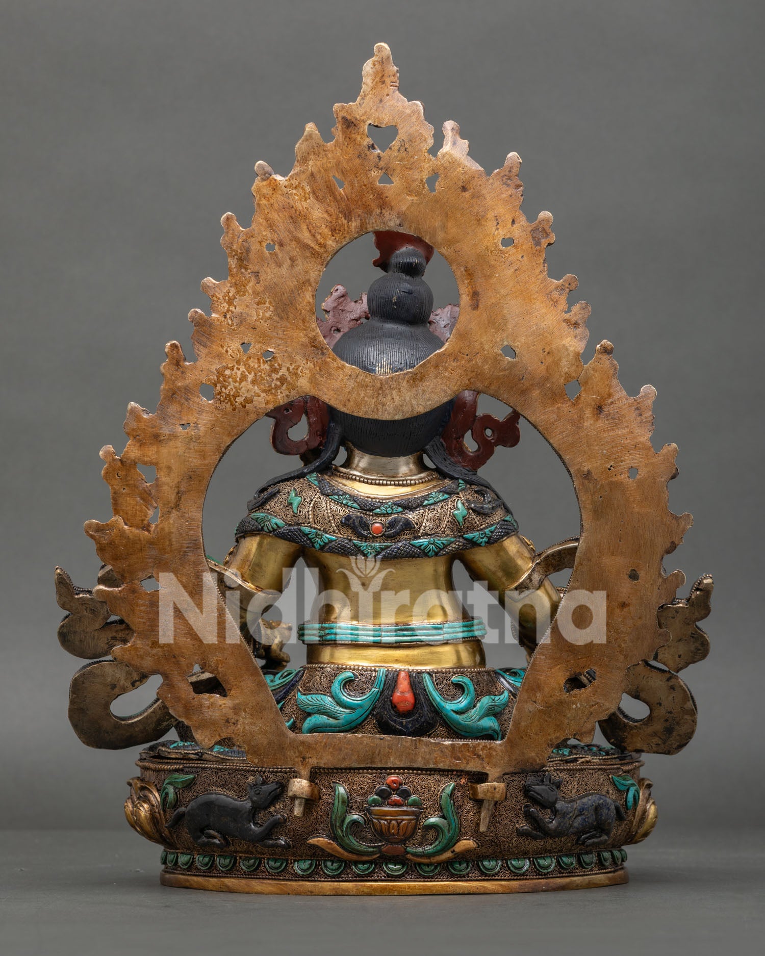 Yellow Dzambhala Statue back view with handcrafted copper repoussé detailing