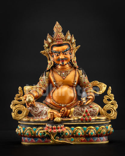 Yellow Dzambhala statue front view seated on a multicolored lotus throne