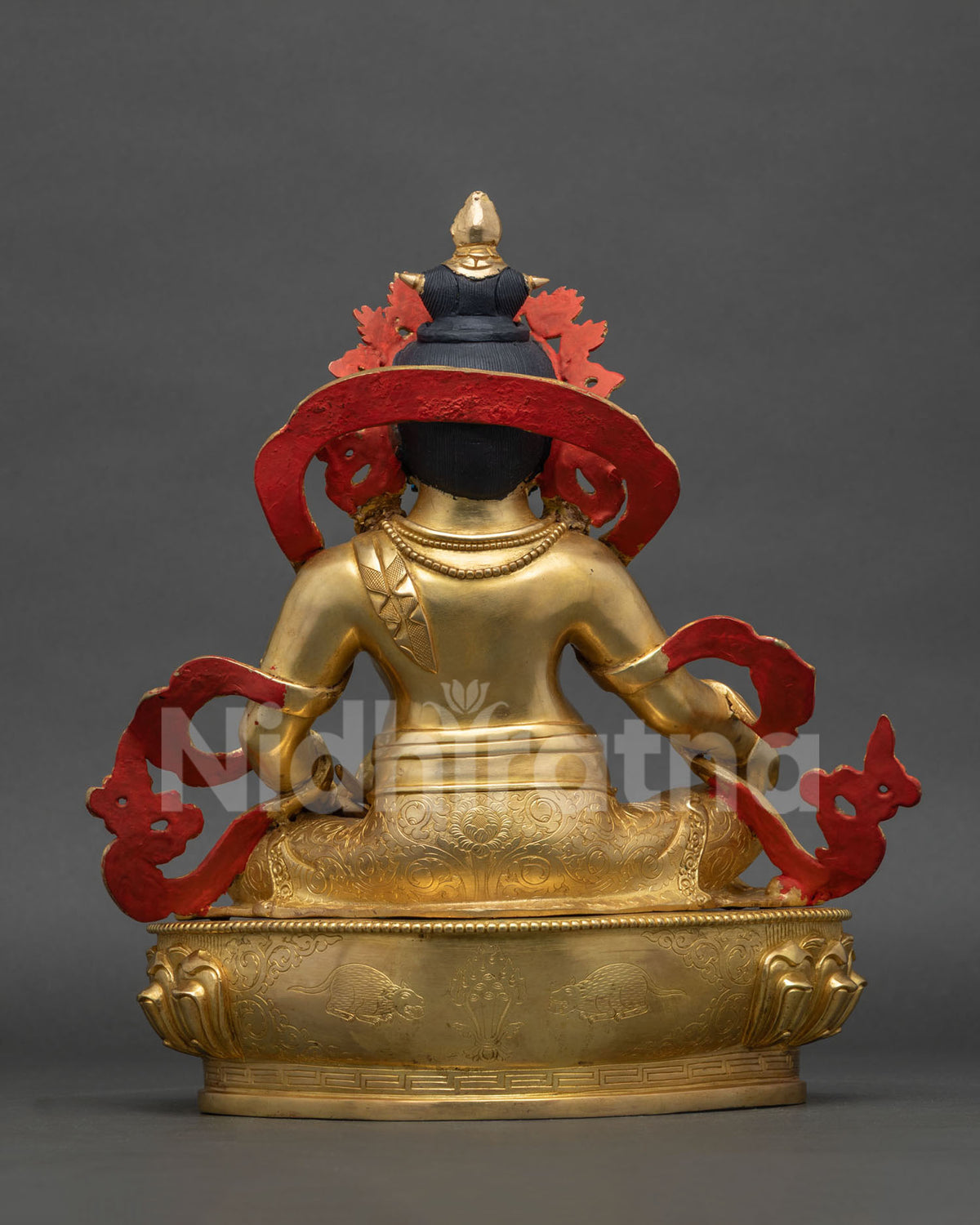 yellow dzambhala statue intricate copper craftsmanship and lotus throne back view
