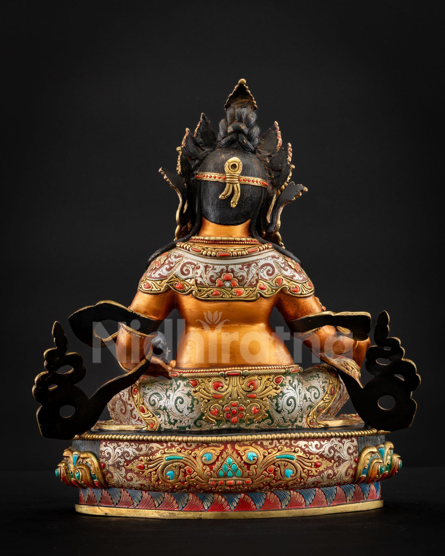 Yellow Dzambhala statue rear view showing crown and robe details
